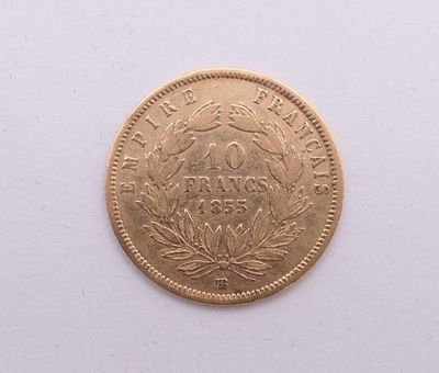 gros plan d'une pièce d'or sur une surface blanche
