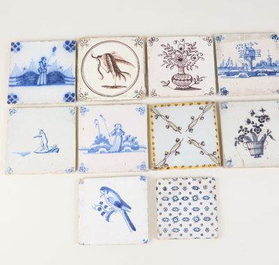 several blue and white tiles with birds and flowers on them