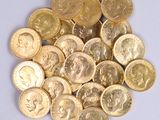 a pile of gold coins sitting on a white surface