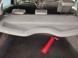 the interior of a car with the back seats folded down and a red object in the trunk