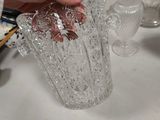 a person pouring something into a glass on a table