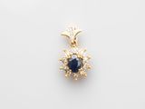 a sapphire and diamond pendant on a white background