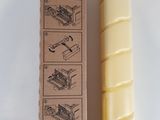 a picture of a candle that is sitting next to a box of wax