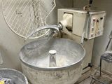 a dirty bathroom with a sink and a fan in it