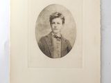 an old photo of a young man in a suit and bow tie