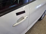 a close up of a car door with a clock on it