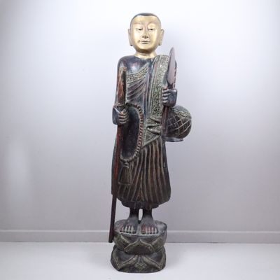 statue of a person holding a knife and a stick
