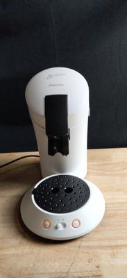 a coffee maker that is sitting on a wooden table
