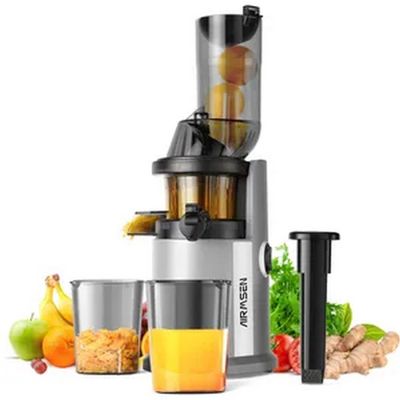 a close up of a juicer sitting next to a glass of juice