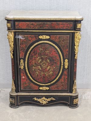 a black and red cabinet with gold trimming and a marble top