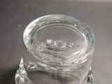 a small glass jar with a lid on a table