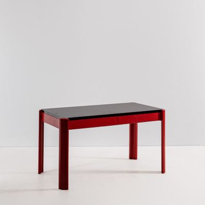 an image of a red table with a black top and legs
