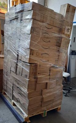 a large stack of boxes sitting on a pallet in a warehouse