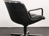 an image of a black office chair sitting on top of a carpeted floor