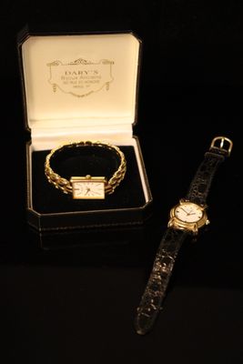 a watch and a bracelet in a box on a table