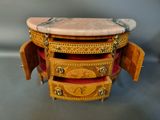 a small wooden table with a marble top on it