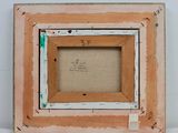 an old picture frame with a picture of a cat in it