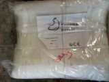 a pillow that is wrapped in plastic and sitting on the ground