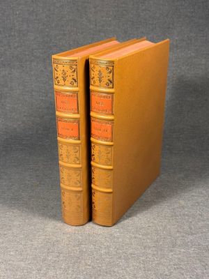 a couple of books sitting on top of each other on a table