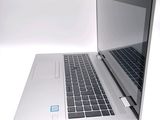 a laptop that is open on a white surface