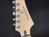 a close up of a guitar neck with a black background