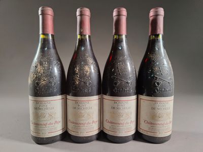three bottles of red wine are lined up on a table