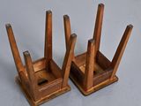 two wooden chairs that are sitting on a table