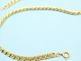 a gold chain with a clasp on a white background