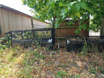 a fence that has a bench in the middle of it