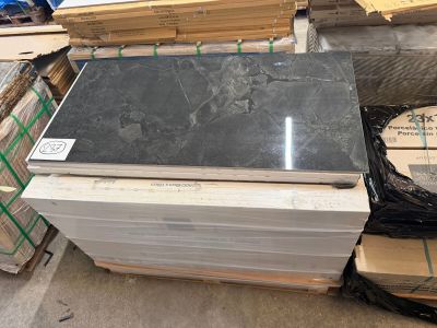 a pile of black granite on a pallet in a warehouse