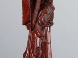 wooden statue of a man holding a sword on a wooden table