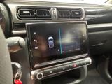 the interior of a car with a radio and a steering control