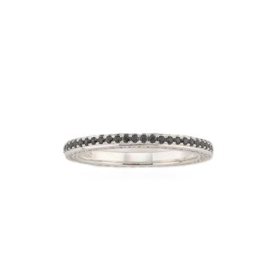 a close up of a ring with black diamonds on a white background