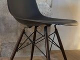 a black chair with a wooden leg and a black seat