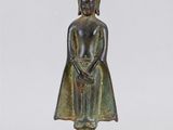une statue en bronze représentant une personne portant un chapeau sur la tête