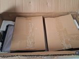 a cardboard box that has a pair of scissors in it
