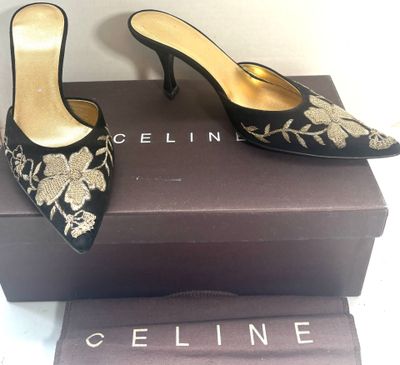 un gros plan sur une paire de chaussures noires posées sur une boîte