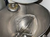 a metal bowl with a whisk inside of it