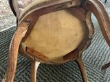 a wooden chair with a tan seat and a tan cushion