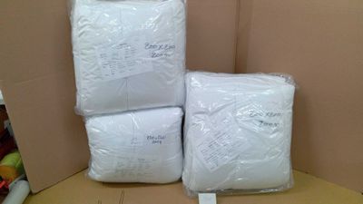 three bags of toilet paper sitting on top of a cardboard box