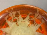 an orange bowl with a picture of a group of birds on it