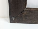 the frame is made of wood and has a small hole in it