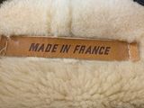 a label on the back of a sheepskin jacket