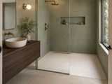 a large bathroom with a walk in shower next to a sink
