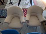 two chairs that are sitting next to each other in a room