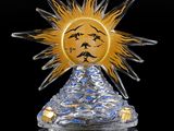 crystal sun with face on top of a crystal pyramid on a reflective surface