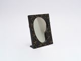 a small mirror sitting on top of a table
