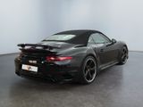 the back of a black porsche sports car parked in a room