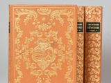 a pair of books sitting on top of each other on a table