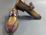 pair of men ' s hand painted shoes on a grey surface